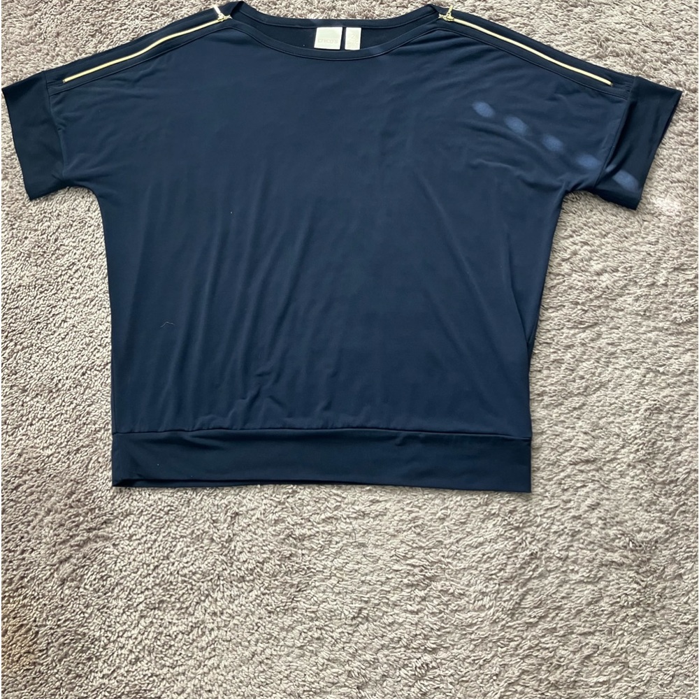 Chicos navy knot top with gold accent zippers on shoulder.